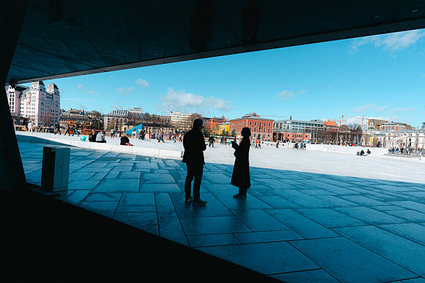 Stockholm, Sweden March 8, 2025 A person walks in the modern downtown on a sunny day.