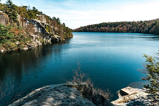 istock Lake Awosting glistens under a clear sky, bordered by rugged cliffs and forested hillsides in Minnewaska State Parka serene gem perfect for nature lovers. 2212252304