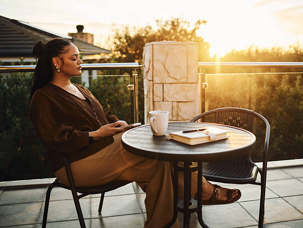 istock Serene Woman Relaxing Outdoors at Sunset 2212253503