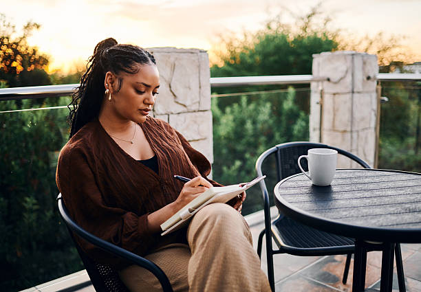 Serene Woman Journaling Outdoors at Sunset