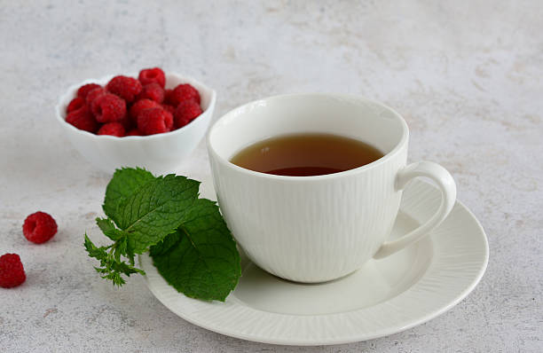 istock A cup of raspberry tea with fresh raspberries and mint 2212257939