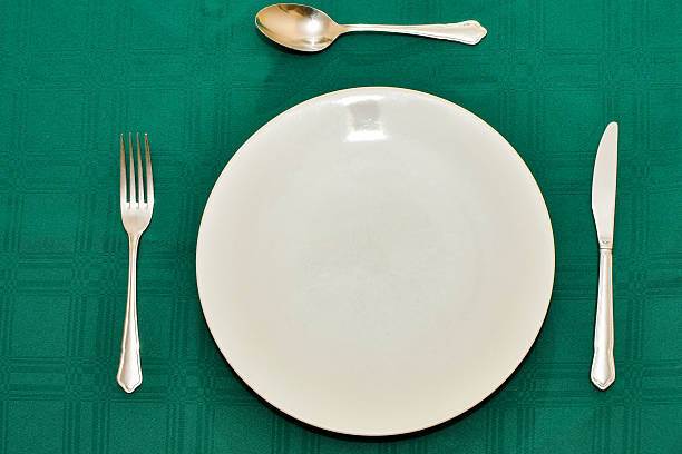 istock Close up view of a table setting on a dark green tablecloth 2212263194