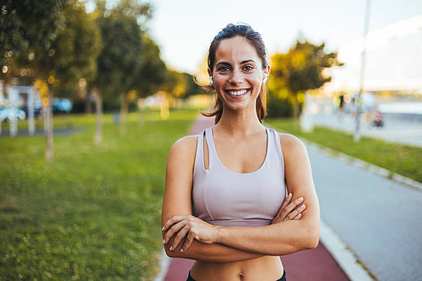 istock Smiling Fit Woman in Activewear Posing Outdoors on a Sunny Day 2212264925