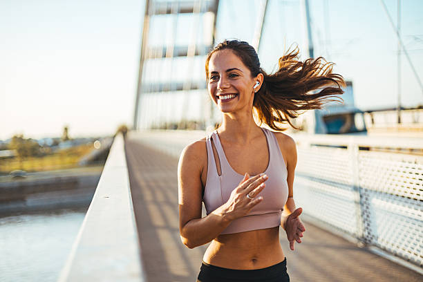 istock Woman Jogging on a Bridge During a Sunny Morning 2212265036