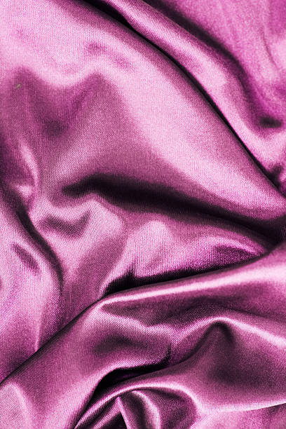 istock Soft and lustrous deep pink satin fabric with elegant draping and rich texture 2212265265