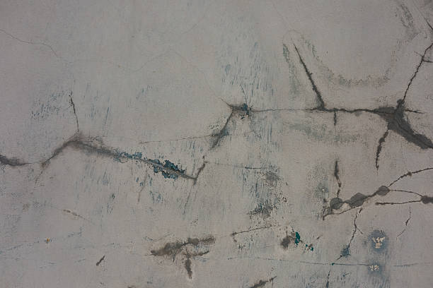 istock Cracked concrete surface revealing texture details in urban setting during daylight hours 2212265467