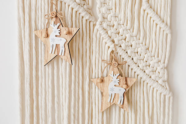 istock Wooden star decorations hang elegantly on a woven wall in a cozy indoor setting during wintertime 2212265904