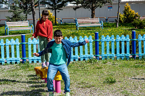 Children doing foot balancing on the playground