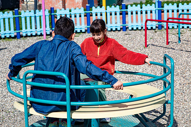 Children on the rotating machine at the playground