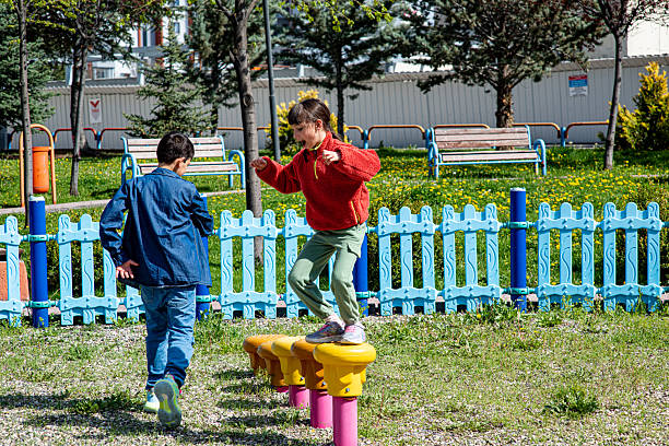 Children doing foot balancing on the playground