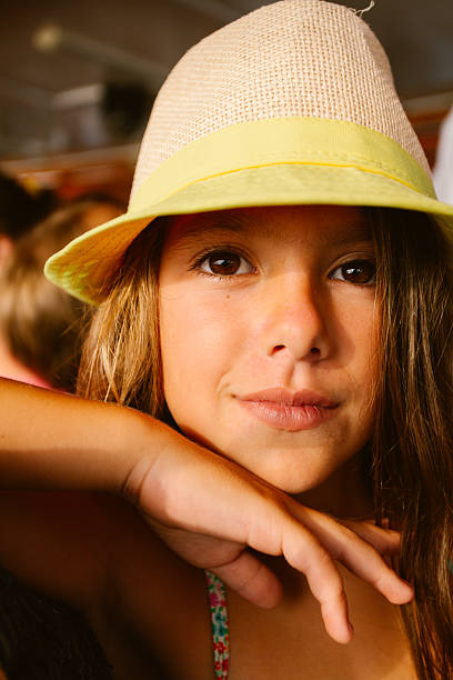 Woman, fashion and summer country charm, blonde beauty and elegance in wide brimmed beach hat. Feminine allure, timeless style and graceful glow. Smile, straw hat and blue striped blouse, natural lighting and effortless charm, fashion look idea