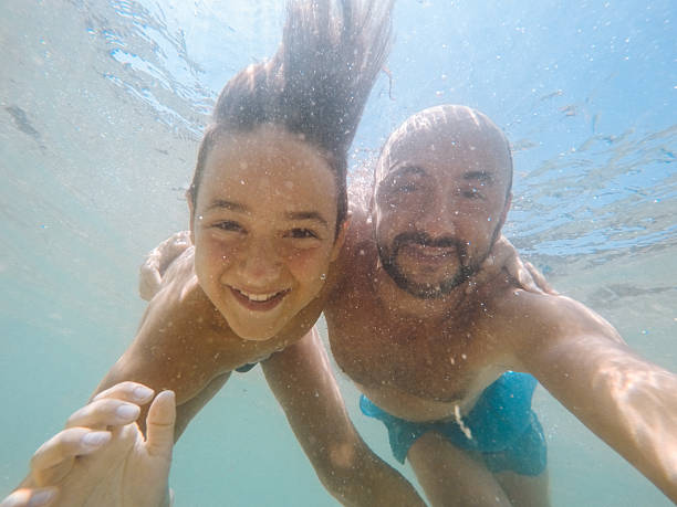 istock Underwater Moments: A Father and Son Selfie 2212278772