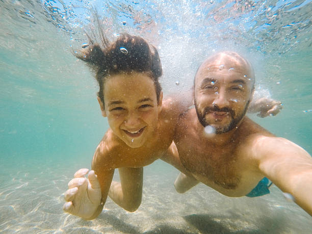 istock Underwater Moments: A Father and Son Selfie 2212278813