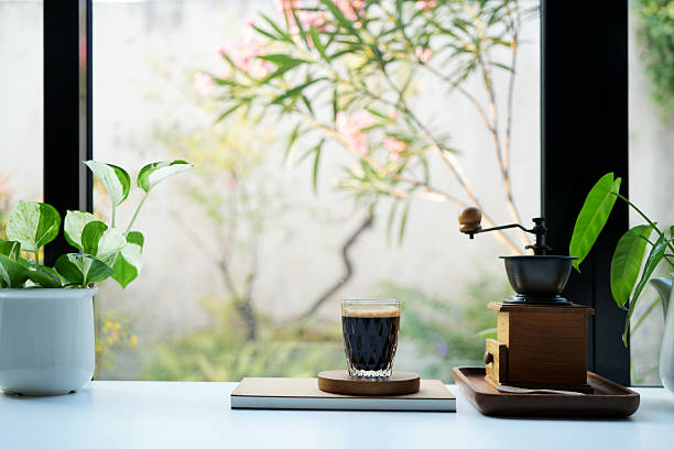 istock Coffee glass cup and plant pot, coffee grinder by the window 2212281221