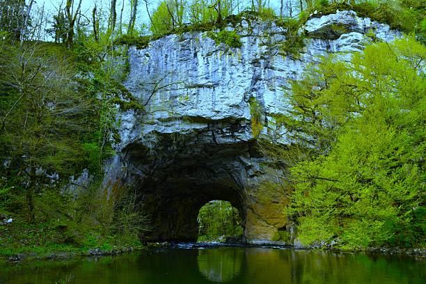 Big natural bridge limestone karst formation with Rak river bellow in Notranjska, Slovenia