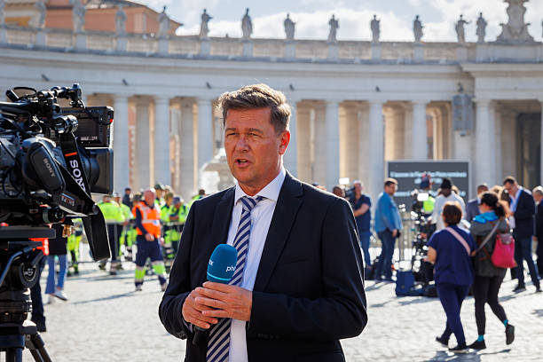 International television journalist documents live news stock photo
