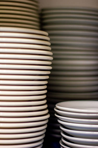 istock stacks of white plates 2212290668