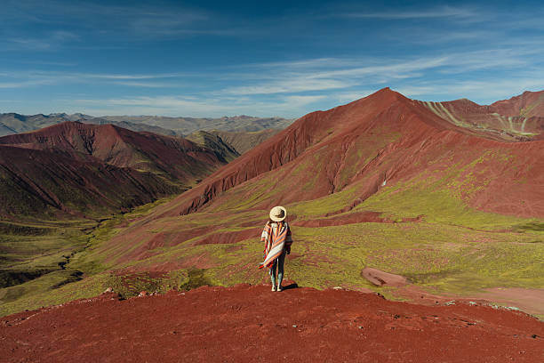 istock Woman looking at Vinicunca Rainbow mountain during trip to Peru 2212291949