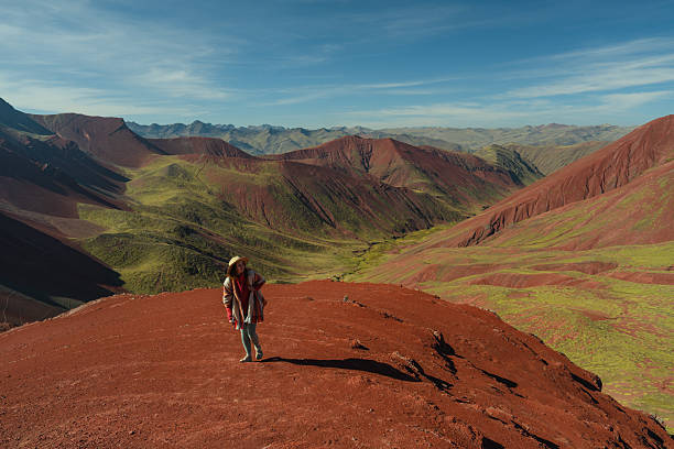 istock Woman looking at Vinicunca Rainbow mountain during trip to Peru 2212291951
