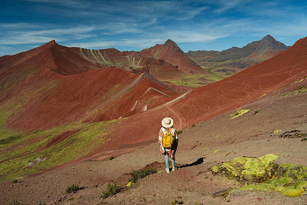 istock Woman looking at Vinicunca Rainbow mountain during trip to Peru 2212291954