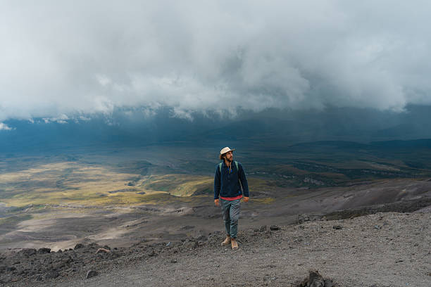 Serene man hiking at Cotopaxi volcano basecamp in Ecuador