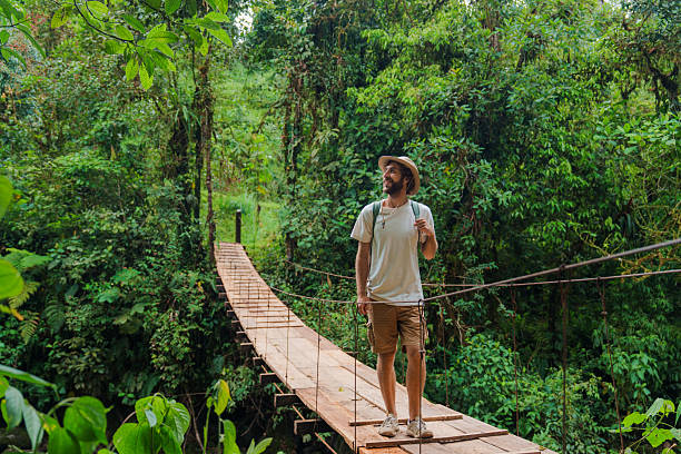 istock Man hiking  during bird watching trip in jungles in Mindo, Ecuador 2212292256