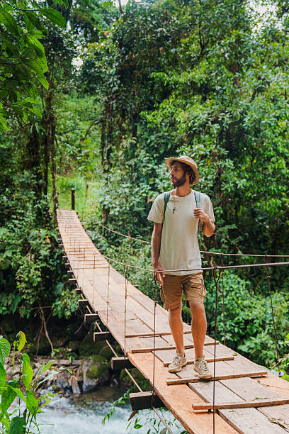 istock Man hiking  during bird watching trip in jungles in Mindo, Ecuador 2212292326