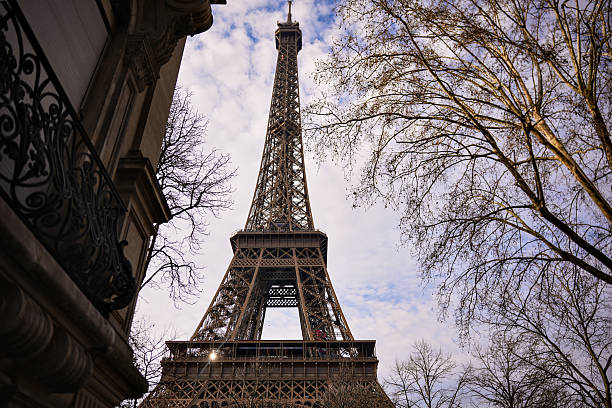 istock Eiffel Tower Against Bright Winter Sky with Parisian Architecture 2212296326
