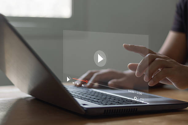 istock Concept about subscription based live digital stream. Video streaming on internet. Man hands using laptop computer for streaming and watching online movie, TV series, live concert, show or tutorial. 2212298592