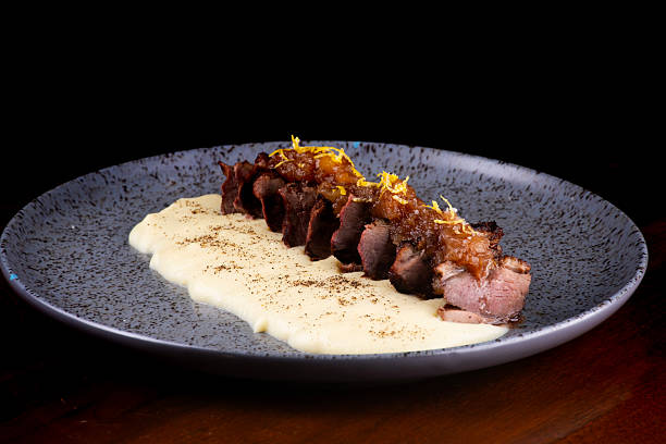istock duck magret served with parmesan cream and angled apricot jam 2212304298