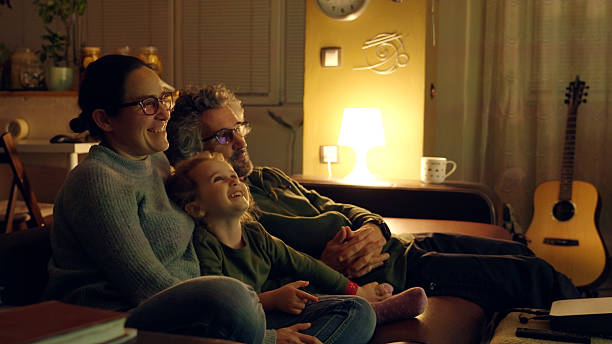 istock Happy Family With Child Having Binge Watching Night on Couch 2212305302