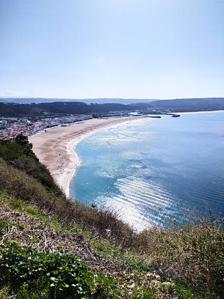 istock Scenic view overlooking a beach with sparkling ocean waves. Represents relaxation, travel, and coastal beauty. Ideal for tourism, vacation, and lifestyle themes. 2212305828