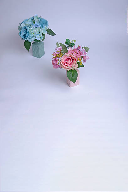 Beautiful colorful flower bouquet with blank blue card over white background