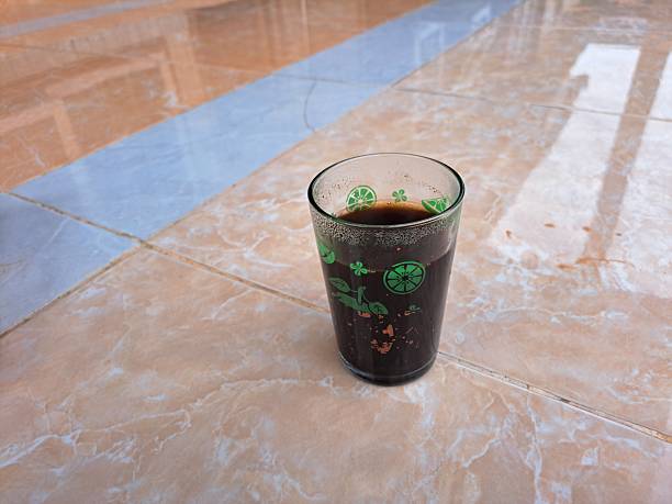 a glass of black coffee on ceramic