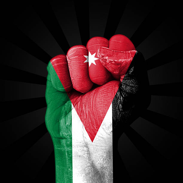 Jordan flag painted on the fist with black backdrop representing freedom, independence, rights, voice