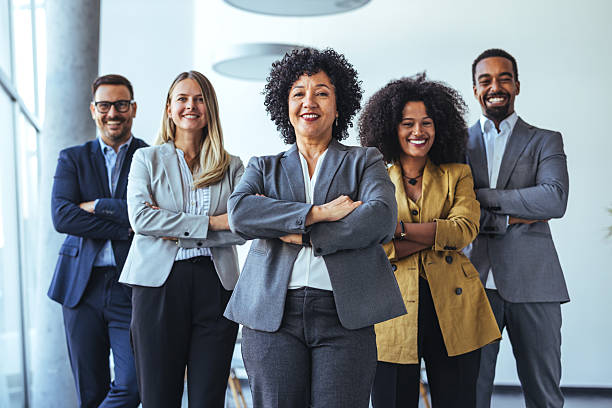 istock Diverse Group of Confident Professionals Smiling in a Bright Office Setting 2212312099
