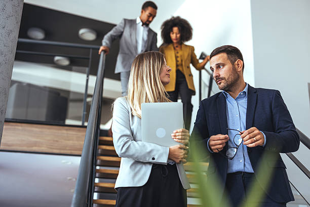 istock Professional Business Team Discussion on Office Staircase in Modern Workspace 2212312151