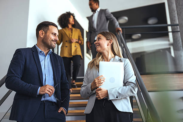 istock Professional Coworkers Interacting Casually on Office Staircase During Workday 2212312165
