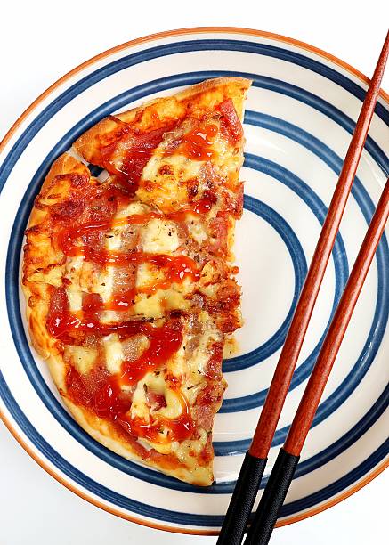 Pizza and Chopsticks on plate.