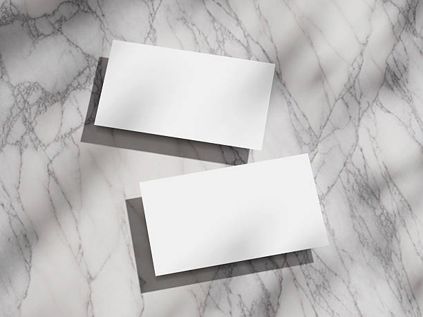 istock Clean and modern business card mockup set on a marble background, with a focus on shadows. 2212321354