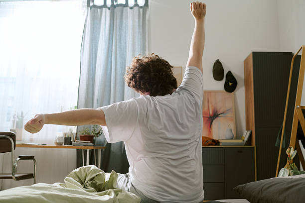 istock Stretching in Cozy Bedroom on Sunny Morning 2212321386