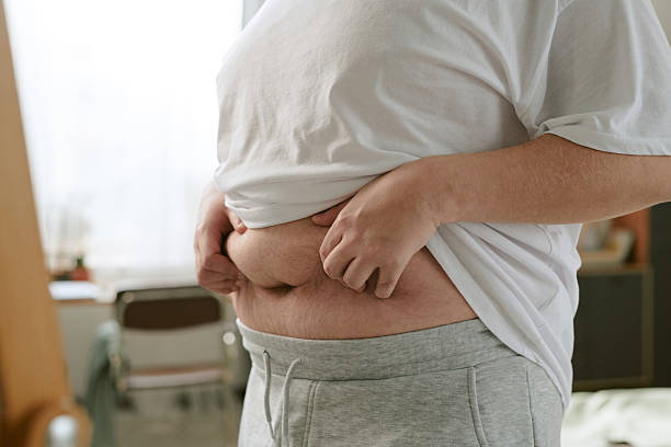 istock Showing Belly While Holding Shirt Up Indoors 2212321710