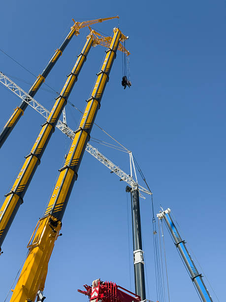 istock Construction cranes. View from below. Crane used to construct palaces, houses or buildings. Construction site. General contest 2212323044
