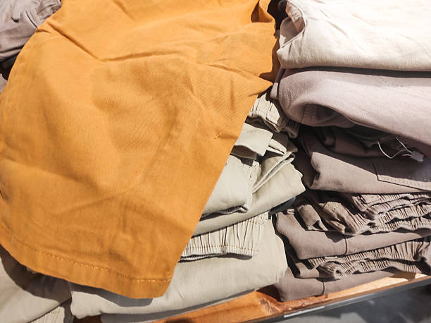 istock Stacks of discounted clothes and pants 2212323073