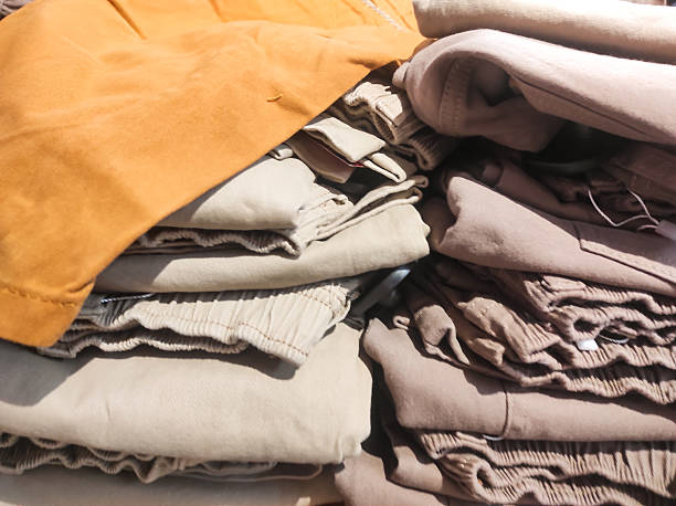 istock Stacks of discounted clothes and pants 2212323086