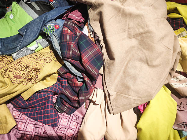 istock Stacks of discounted clothes and pants 2212323111
