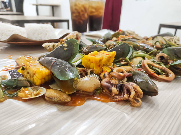 Photo of a complete package of seafood dishes with padang sauce. Seafood with various types of shellfish, shrimp, crab and squid. Gourmet Industry. Food and drinks. Indonesian cuisine