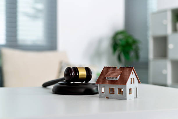 istock Model house and gavel on the table 2212325937