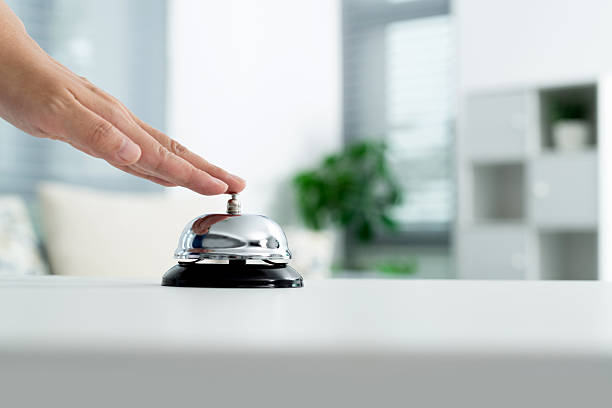 istock Woman hand ringing a service bell 2212325939