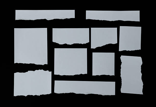 istock Many pieces of torn paper on black background 2212326003